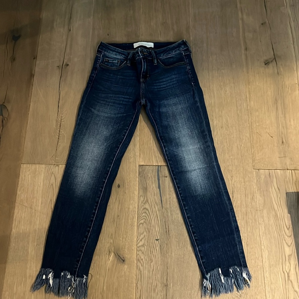 blue jeans with cuts on the bottom